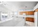 Open kitchen with natural wood cabinetry, bar top, tile floors, and ample natural light at 3854 Spruceview Ct, Las Vegas, NV 89147