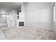 Open living room with neutral carpet, fireplace, and access to the kitchen at 3854 Spruceview Ct, Las Vegas, NV 89147