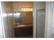 Stylish bathroom with framed mirror over vanity with granite counters and shower stall at 4050 Pacific Harbors Dr # 107, Las Vegas, NV 89121