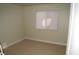 Bedroom showcasing neutral carpet and walls, plus a bright window for natural lighting at 4050 Pacific Harbors Dr # 107, Las Vegas, NV 89121