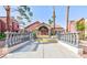 Clubhouse entrance with a red tile roof, a concrete courtyard, and double doors at 4050 Pacific Harbors Dr # 107, Las Vegas, NV 89121