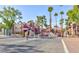 Gated community entrance featuring brick buildings, mature landscaping, and ample parking at 4050 Pacific Harbors Dr # 107, Las Vegas, NV 89121