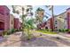 Landscaped grounds with mature trees, shrubs, and walking paths between buildings at 4050 Pacific Harbors Dr # 107, Las Vegas, NV 89121