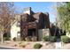 Exterior view of a brown and tan two-story building with well-maintained landscaping at 4050 Pacific Harbors Dr # 107, Las Vegas, NV 89121