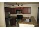 Galley kitchen with granite countertops, stainless steel appliances, and wood cabinets at 4050 Pacific Harbors Dr # 107, Las Vegas, NV 89121