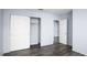 This bedroom includes a closet, wood floors and a view of an ensuite at 4050 Pacific Harbors Dr # 245, Las Vegas, NV 89121