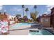 Community pool with a hot tub, chaise lounges, and mature landscaping at 4050 Pacific Harbors Dr # 245, Las Vegas, NV 89121