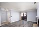 Living room featuring new floors, neutral paint, and sliding glass door with a fireplace at 4050 Pacific Harbors Dr # 245, Las Vegas, NV 89121