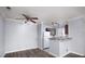 Open-concept living space with hardwood floors, a kitchen bar and a ceiling fan at 4050 Pacific Harbors Dr # 245, Las Vegas, NV 89121