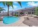 Backyard featuring a pool, patio, and lush tropical landscaping at 4244 Totano Dr, North Las Vegas, NV 89032