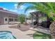 Outdoor living space with covered bar, patio furniture, synthetic grass, and an inviting pool at 4244 Totano Dr, North Las Vegas, NV 89032