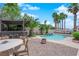 Relaxing backyard featuring a pool, patio seating, and a covered outdoor bar area at 4244 Totano Dr, North Las Vegas, NV 89032