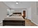 Bright bedroom with a wooden bed frame, white ceiling fan, and natural light from the window at 4244 Totano Dr, North Las Vegas, NV 89032