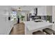 Bright kitchen features white cabinets, stainless steel appliances, and a white countertop breakfast bar with seating at 4244 Totano Dr, North Las Vegas, NV 89032