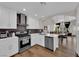 Bright kitchen features white cabinets, stainless steel appliances, and an open concept living area at 4244 Totano Dr, North Las Vegas, NV 89032