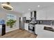 Bright kitchen features white cabinets, stainless steel appliances, and a window at 4244 Totano Dr, North Las Vegas, NV 89032