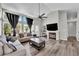 Living room with a fireplace, new flooring and large windows at 4244 Totano Dr, North Las Vegas, NV 89032