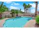 Inviting backyard pool with palm trees and lounge area perfect for outdoor relaxation and entertaining at 4244 Totano Dr, North Las Vegas, NV 89032