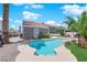 A backyard pool and patio featuring a bar area and lush greenery that provides a relaxing and private outdoor retreat at 4244 Totano Dr, North Las Vegas, NV 89032