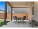 Relaxing covered back patio featuring sleek outdoor furniture and a cozy ambiance at 438 Shimmering Sands Ave, North Las Vegas, NV 89031