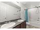 Bathroom featuring double sinks, granite countertops, and a shower-tub combo at 438 Shimmering Sands Ave, North Las Vegas, NV 89031