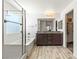 Bathroom features a walk-in glass shower, separate soaking tub, double sink vanity, and wood-style flooring at 438 Shimmering Sands Ave, North Las Vegas, NV 89031