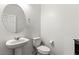 Bright half-bathroom featuring a pedestal sink and modern fixtures at 438 Shimmering Sands Ave, North Las Vegas, NV 89031