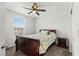 Bright bedroom featuring a window view, floral bedding, and a side table at 438 Shimmering Sands Ave, North Las Vegas, NV 89031