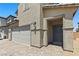 Close up of a gray two-story home featuring a two car garage, neutral color palette, and low maintenance yard at 438 Shimmering Sands Ave, North Las Vegas, NV 89031