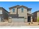 Charming two-story home featuring desert landscaping, neutral color palette, and attached two car garage at 438 Shimmering Sands Ave, North Las Vegas, NV 89031
