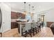 Open kitchen featuring granite counters, kitchen island, stainless steel appliances and barstool seating at 438 Shimmering Sands Ave, North Las Vegas, NV 89031