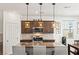 Kitchen boasts granite counters, kitchen island with seating, stainless steel appliances and wood cabinets at 438 Shimmering Sands Ave, North Las Vegas, NV 89031