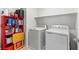 Functional laundry room equipped with modern washer and dryer units for convenience at 438 Shimmering Sands Ave, North Las Vegas, NV 89031