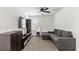 Cozy carpeted living room with a gray sectional sofa, media center, and a flat screen television at 438 Shimmering Sands Ave, North Las Vegas, NV 89031