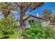Secluded backyard view featuring beautiful landscaping and a glimpse of the home's exterior at 4905 Ocean Shores Way, Las Vegas, NV 89130