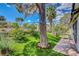 Lush backyard with artificial lawn, mature tree, and a brick-paved patio, perfect for outdoor relaxation at 4905 Ocean Shores Way, Las Vegas, NV 89130