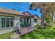 Charming backyard showcases manicured artificial lawn, brick patio, mature tree and home's exterior at 4905 Ocean Shores Way, Las Vegas, NV 89130