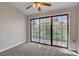 This bedroom features a sliding glass door and neutral carpeting and paint at 4905 Ocean Shores Way, Las Vegas, NV 89130