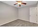 Comfortable bedroom with a ceiling fan, neutral walls, and plush carpet flooring at 4905 Ocean Shores Way, Las Vegas, NV 89130