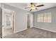 Neutral bedroom with carpet, ceiling fan, closet, and view to another room at 4905 Ocean Shores Way, Las Vegas, NV 89130
