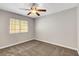 Cozy bedroom with a ceiling fan, neutral walls, and plush carpet flooring at 4905 Ocean Shores Way, Las Vegas, NV 89130