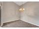 Cozy dining room with carpet and decorative lighting fixture at 4905 Ocean Shores Way, Las Vegas, NV 89130