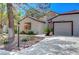 Single-story home with mature trees, desert landscaping, and a two-car garage at 4905 Ocean Shores Way, Las Vegas, NV 89130