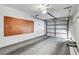 This garage features an automatic garage door, pegboard, and concrete flooring at 4905 Ocean Shores Way, Las Vegas, NV 89130