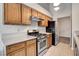 Traditional kitchen featuring wood cabinets, stainless steel appliances, and light countertops at 4905 Ocean Shores Way, Las Vegas, NV 89130