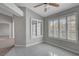 Neutral-toned living room featuring tile flooring, ceiling fan, and windows with shutter blinds at 4905 Ocean Shores Way, Las Vegas, NV 89130