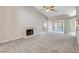 Spacious living room featuring a brick fireplace, new carpet, and natural light from the backyard at 4905 Ocean Shores Way, Las Vegas, NV 89130
