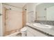 Bathroom featuring a tiled shower, toilet, and granite countertop vanity with decorative mirror and fixtures at 4955 Lindell Rd # 130, Las Vegas, NV 89118