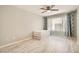 A bedroom featuring neutral walls, wood-look flooring, a ceiling fan and a window with curtains and natural light at 4955 Lindell Rd # 130, Las Vegas, NV 89118