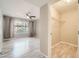 Spacious bedroom featuring wood-like flooring, a ceiling fan, and a well-organized walk-in closet at 4955 Lindell Rd # 130, Las Vegas, NV 89118
